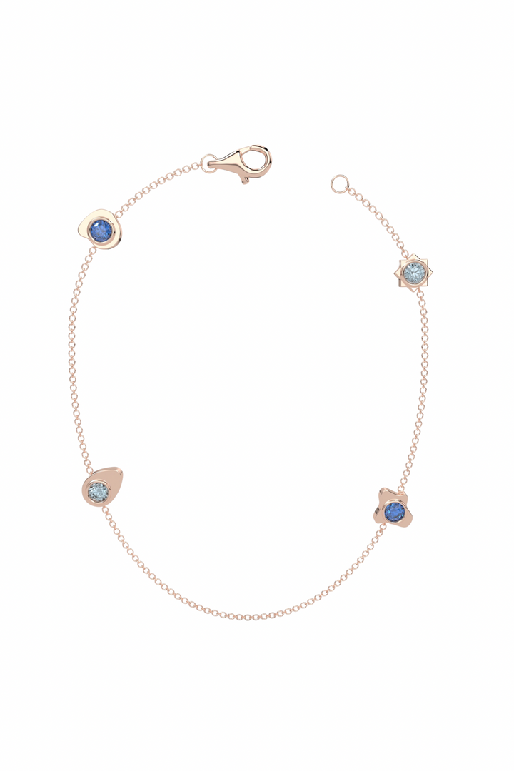 a gold bracelet with blue stones on a white background