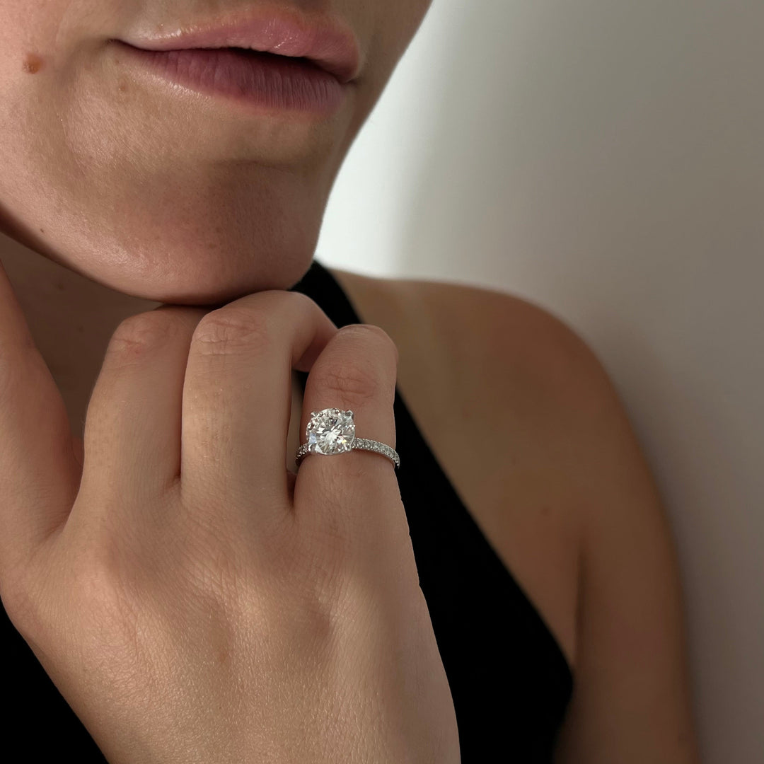 a close up of a person wearing a diamond ring