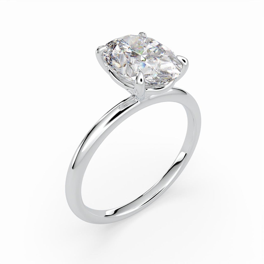 a white gold ring with a cushion shaped diamond