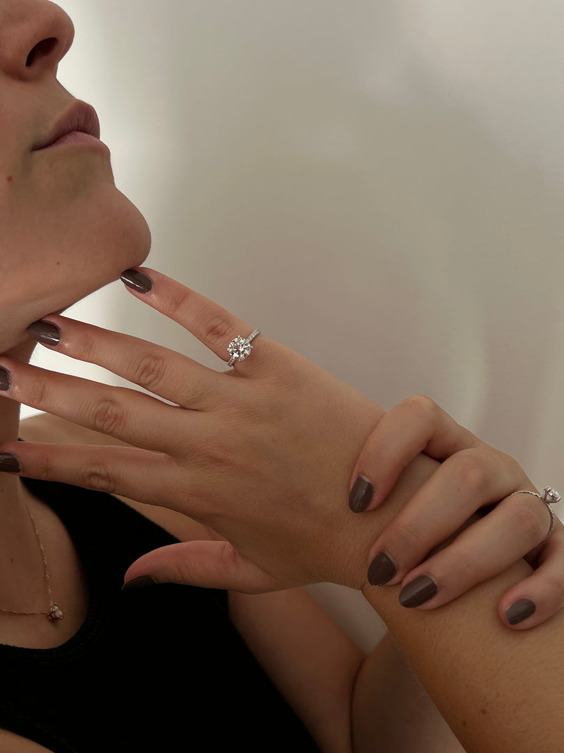 a close up of a person with a ring on her finger