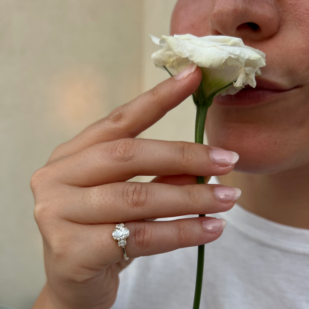 a close up of a person holding a flower