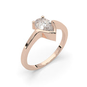 a rose gold ring with a pear shaped diamond