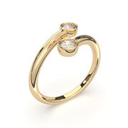 a gold ring with two diamonds on it